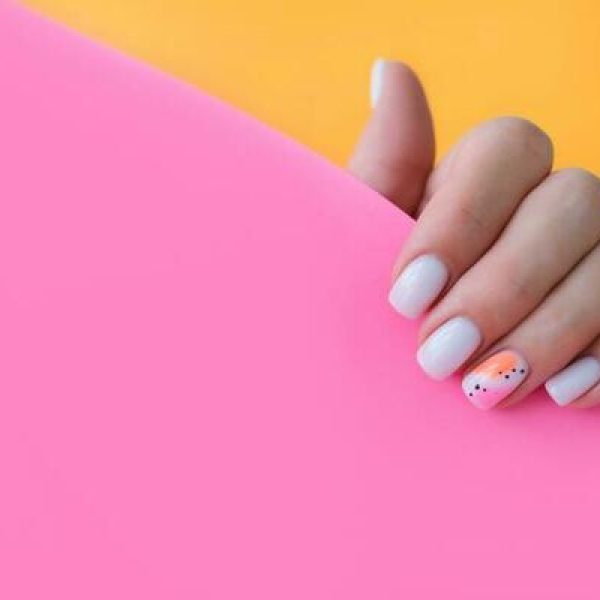 beautiful-female-hands-with-a-manicure-on-a-pink-and-orange-background-shaded-nail-design-summer-manicure-copy-space-photo